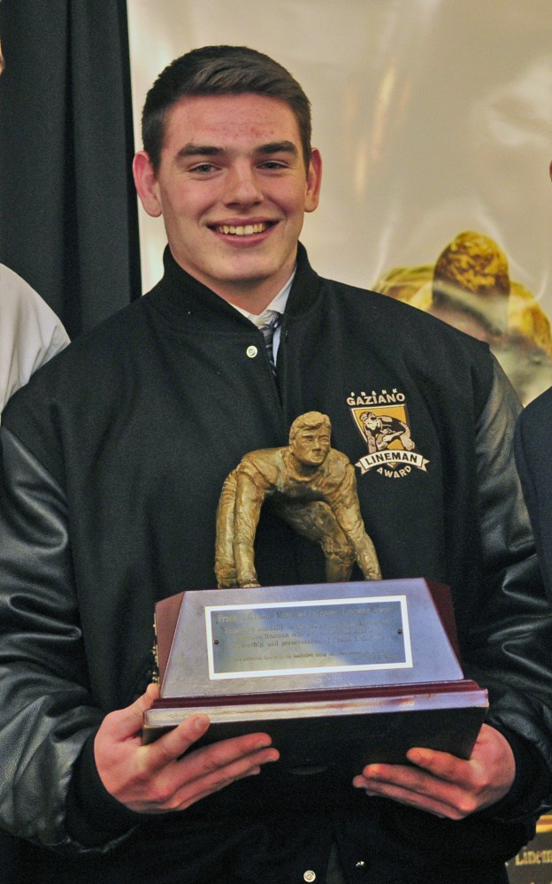 Cheverus senior Frank Curran holds his trophy after he earned the Frank J. Gaziano Defensive Lineman Award on Saturday at the Augusta Civic Center.