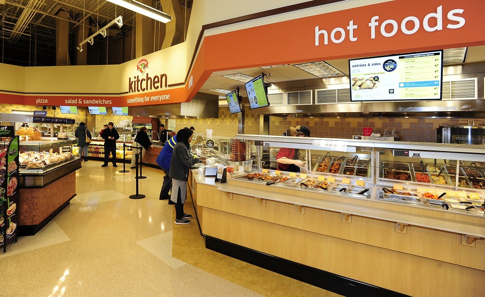 Customers select prepared food at the Forest Avenue Hannaford, where there’s also a seating area and coffee bar. Gordon Chibroski/Staff Photographer