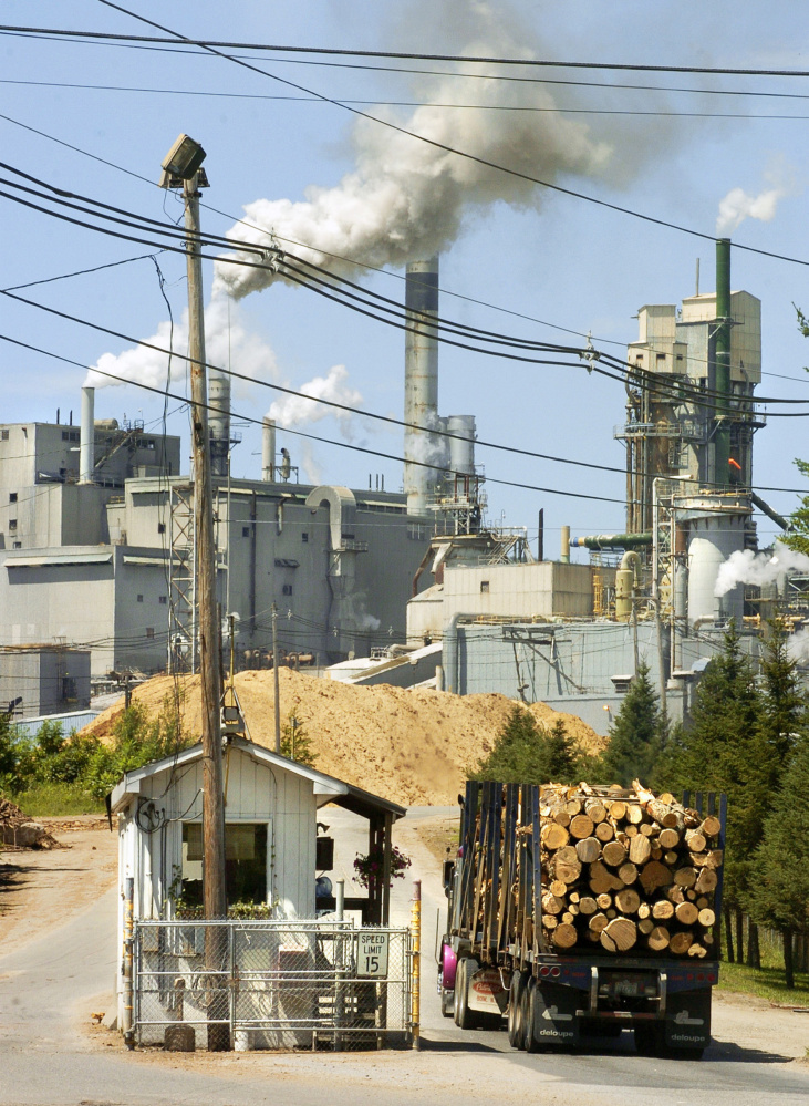 A truck loaded with logs enters International Paper’s Androscoggin Mill in Jay in 2005. Apollo purchased Verso in a leveraged buyout in 2006.