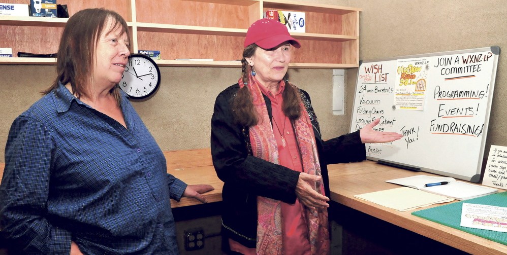 Lolly Phoenix, left, and WXNZ-LP 98.1 radio station manager Annie Stillwater Gray discuss fundraising and work to get the station operational inside the former Somerset County jail in Skowhegan in June. The nonprofit station is holding a fundraiser to help pay license fees and other costs.
