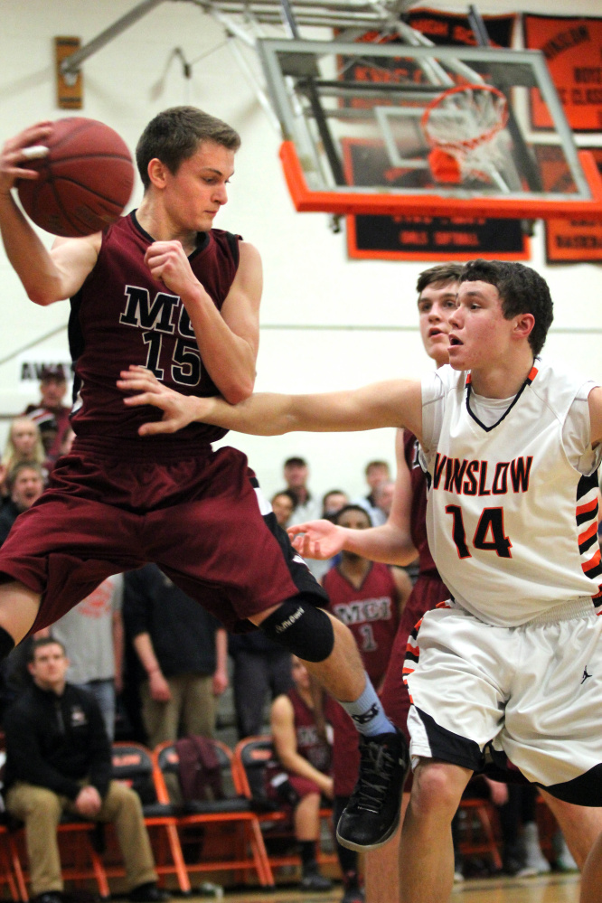 Maine Central Institute’s Josh Buker (15) prepares to throw the ball off Winslow’s Dylan Hutchinson before going out of bounds during first-half action of a Class B North prelimary playoff game Wednesday in Winslow. The ball deflected off Hutchinson and went of out bounds giving the Huskies possession.