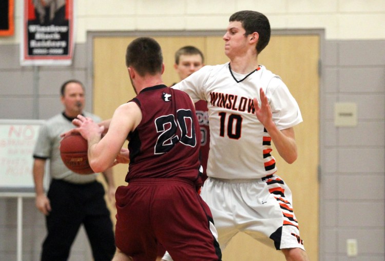 Winslow High School’s Nathan Martin (10) puts pressure on Maine Central Institute’s Carter Pearl during the first half of a Class B North preliminary playoff game Wednesday in Winslow.