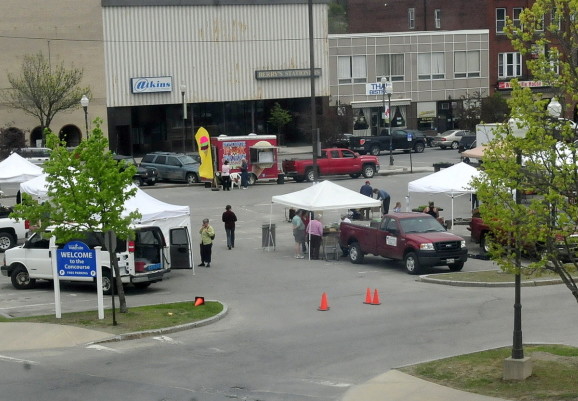 Vendors set up for the farmers market in The Concourse in Waterville, a location where Colby College wants to build a student dormitory as part of downtown revitalization efforts.