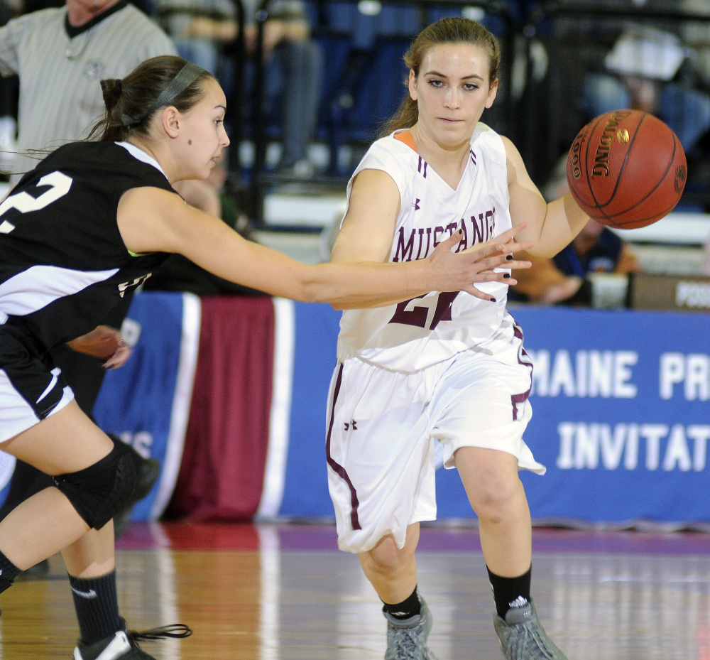 Monmouth’s Sidney Wilson dribbles past St. Dominic’s Rileigh Stebbins during a Class C South quarterfinal Monday at the Augusta Civic Center.