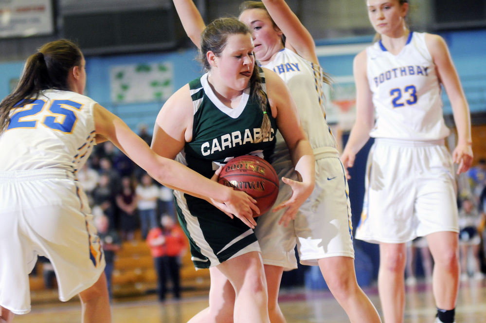 Carrabec’s Kate Stevens dribbles through two Boothbay defenders during a Class C South quarterfinal Monday at the Augusta Civic Center. Boothbay won, 32-17.