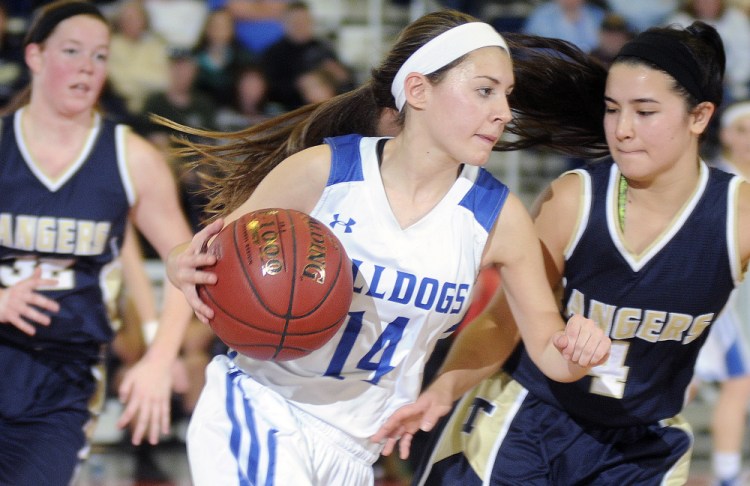 Madison’s Sydney LeBlanc moves around Traip’s Kiara Perez, right, and Reilly Eddy during a Class C South quarterfinal Tuesday at the Augusta Civic Center.