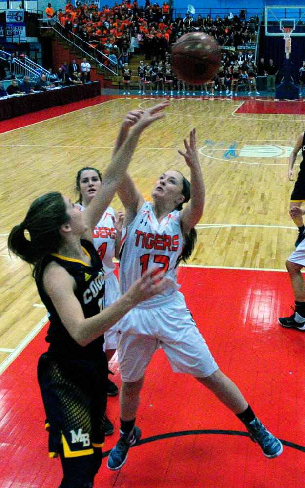 Staff photo by Joe Phelan
Gardiner’s Hailee Lovely and Mt. Blue’s Eryn Dorion, left, go for rebound during a Class A North quarterfinal last Friday at the Augusta Civic Center.