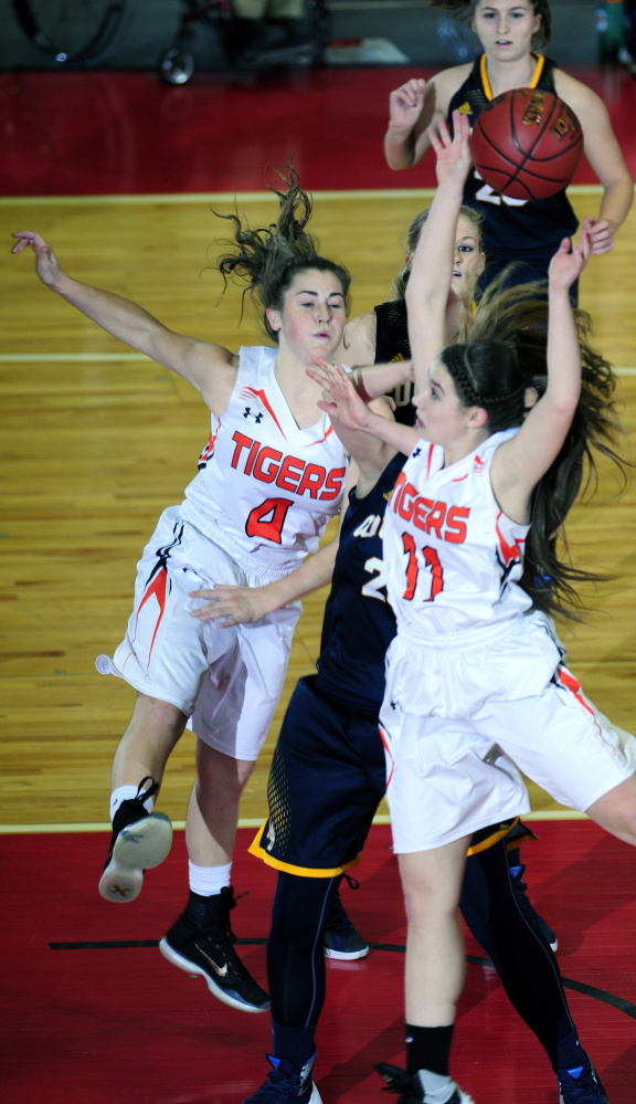 Gardiner’s Lauren Chadwick, left, Mt. Blue’s Mackenzie Harris and Gardiner’s Leslie Stevens battle for a rebound during a Class A North quarterfinal game Friday in the Augusta Civic Center.