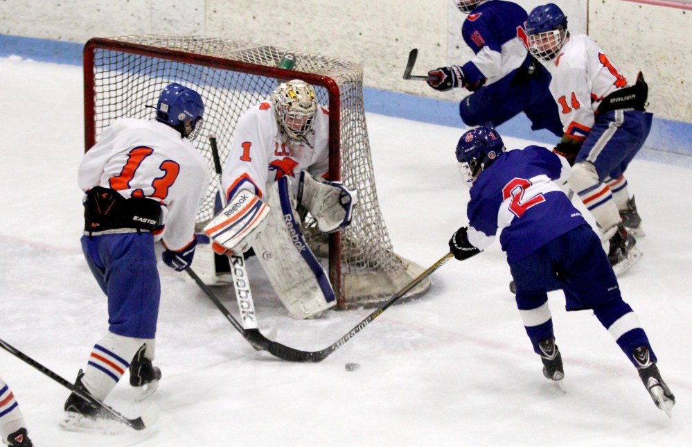 Skowhegan/Lawrence goalie Curtis Martin turns away a scoring opportunity from Mt. Ararat/Lisbon/Morse forward Tyler Lacascio during first period action at Sukee Arena in Winslow on Wednesday night.