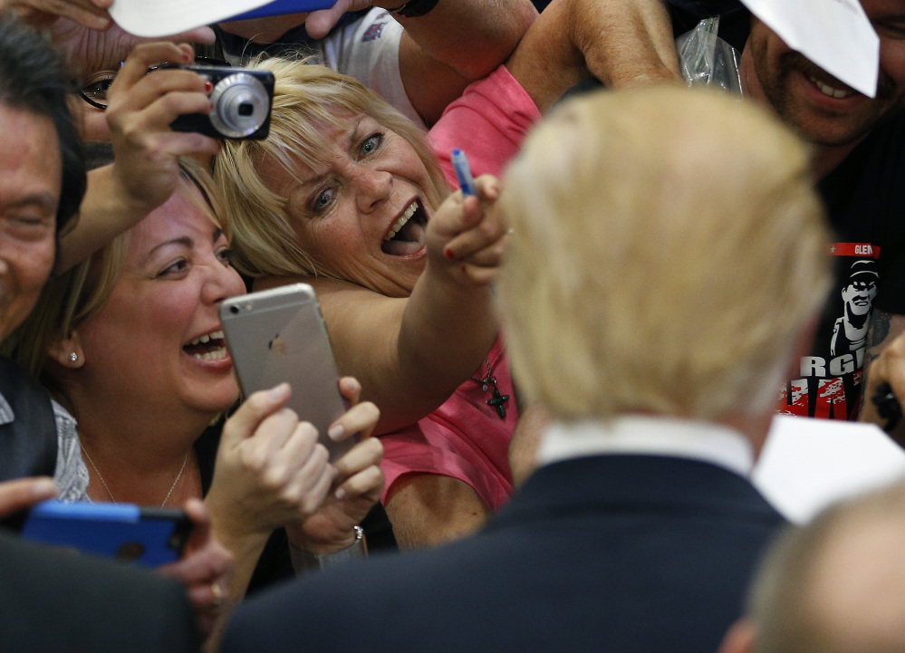 Supporters show their excitement at meeting Republican presidential candidate Donald Trump at a campaign rally Monday in Las Vegas.