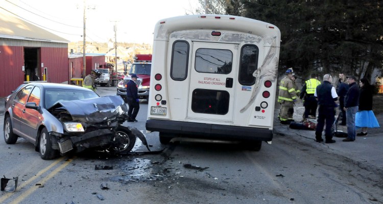 Police, rescue and ambulance personnel speak drivers and passnegers after a Volkswagen Jetta, left,  collided with a Kennebec Valley Community Actin Program van on North Street in Waterville Monday afternoon.