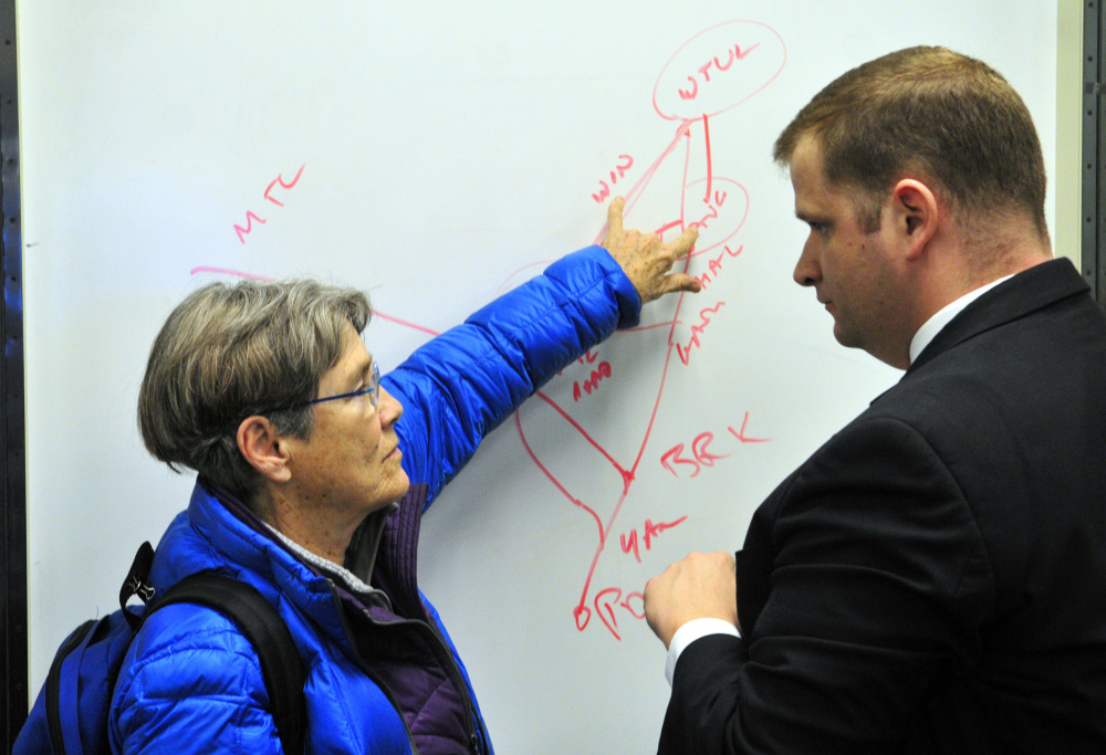 City councilor Dale McCormick, left, and George O’Keefe talk about rail roads on Friday at Augusta City Center.