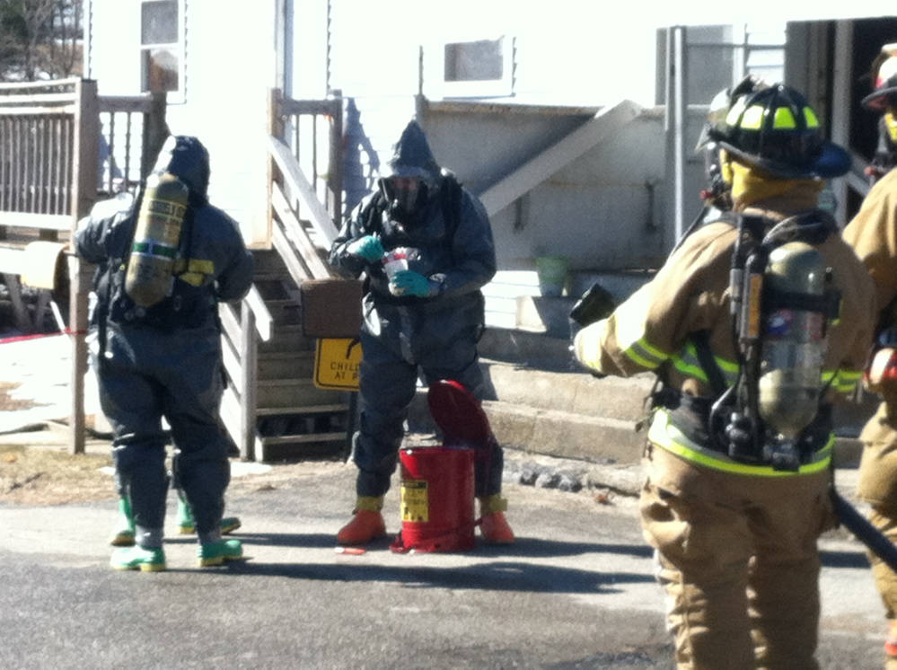 Authorities wearing hazmat suits search a Livermore Falls home Saturday after raiding an alleged meth operation.