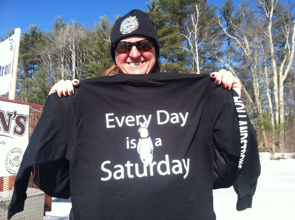 Deborah Roberts, mother of El Faro sinking victim Michael Holland, holds up a T-shirt made for a memorial fishing derby featuring one of her son’s favorite quips.