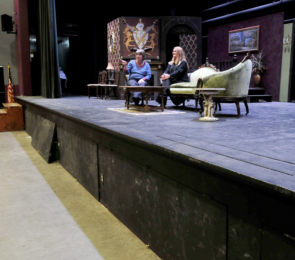 Waterville Senior High School Band Director Sue Barre, left, and Drama Director Gayle Giguere discuss the ongoing auditorium renovation project on the Trask Auditorium stage on Monday. Among the project plans are extending the stage area by 6 feet, replacing the curtains, lights, sound system and installing new seating.