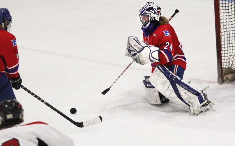 Messalonskee freshman goalie Amber Kochaver makes a save against Camden Hills in the third period of a Class B North semifinal Saturday night at Sukee Arena.