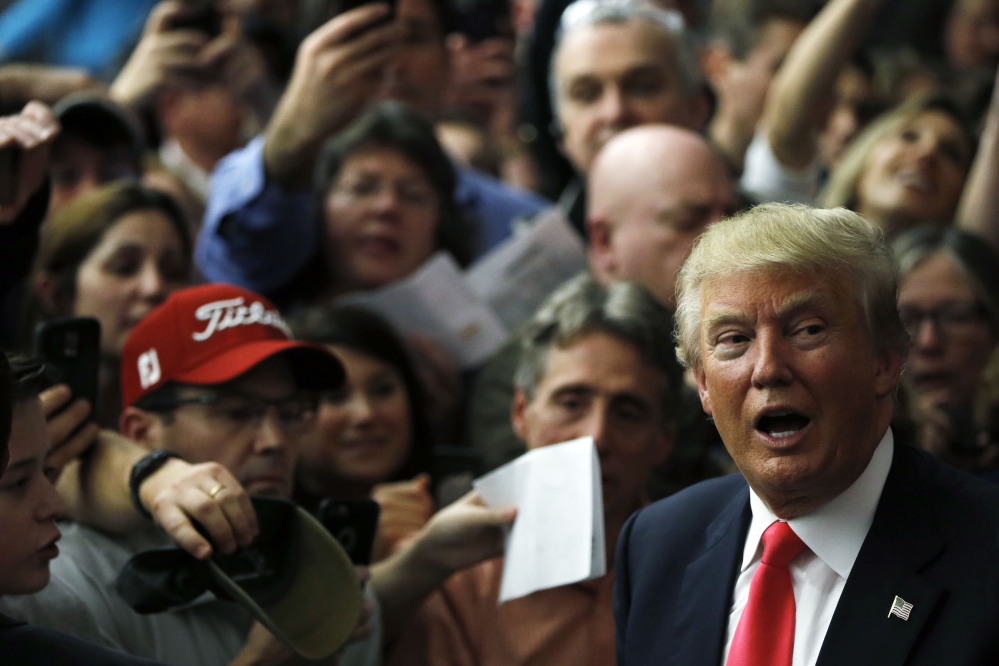 Republican presidential candidate Donald Trump meets with attendees during a campaign stop Tuesday in Milford, N.H. (AP Photo/Matt Rourke)