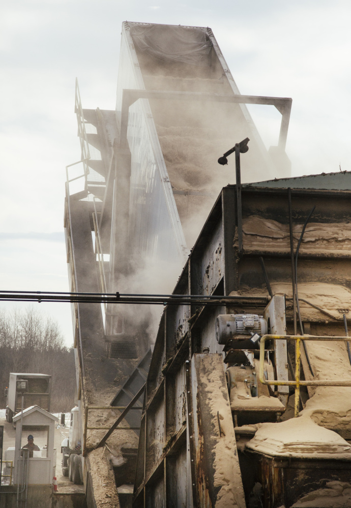 A semi filled with wood biomass fuel is tipped and unloaded at ReEnergy biomass plant in Livermore Falls. (Whitney Hayward/Staff Photographer)