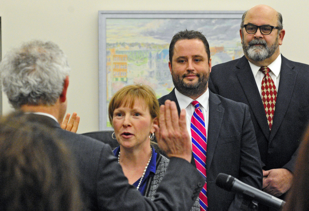 At-large Augusta Councilor Marci Alexander, shown here being sworn-in to office, has asked that iPads be provided to city council members to replace printed documents.