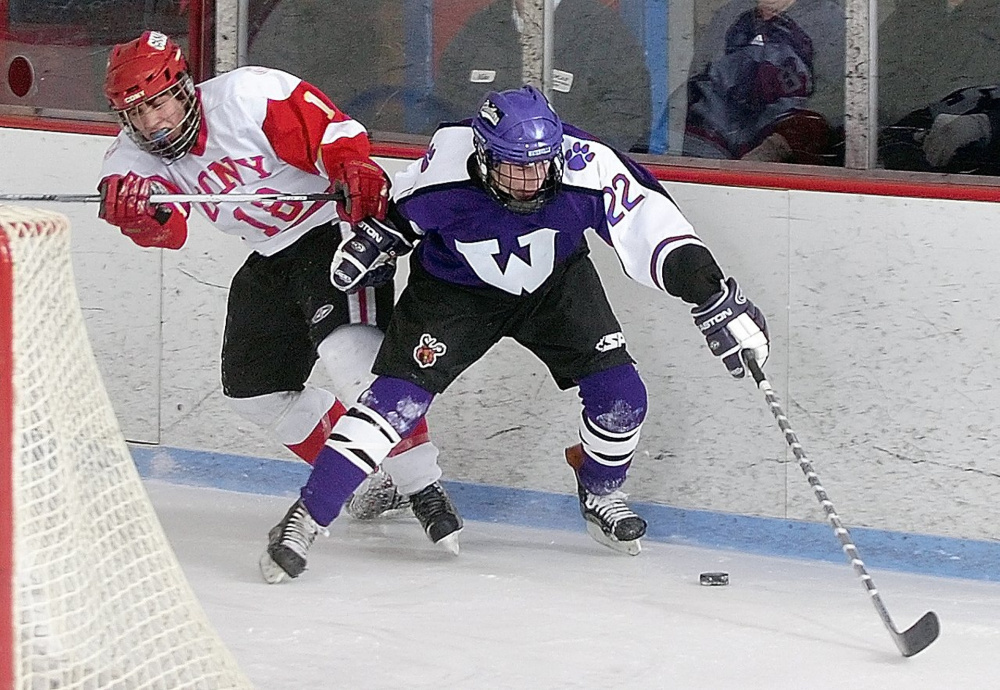 Cony’s Derek Brotherton, left, and Waterville’s Eric Aldrich battle for a puck behind the Cony net during a 2009 game night at the then-Kennebec Ice Arena in Hallowell.