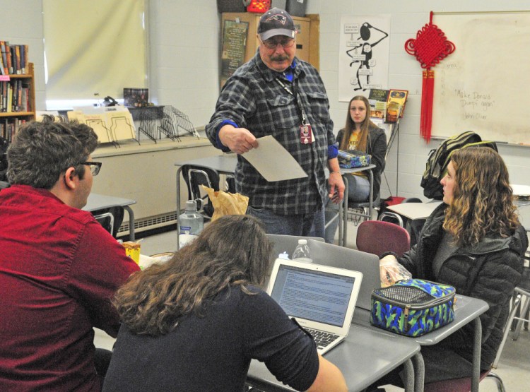 Academic decathlon coach Scott Foyt talks to team members about traveling to Alaska for the national championships on Wednesday at Monmouth Academy.