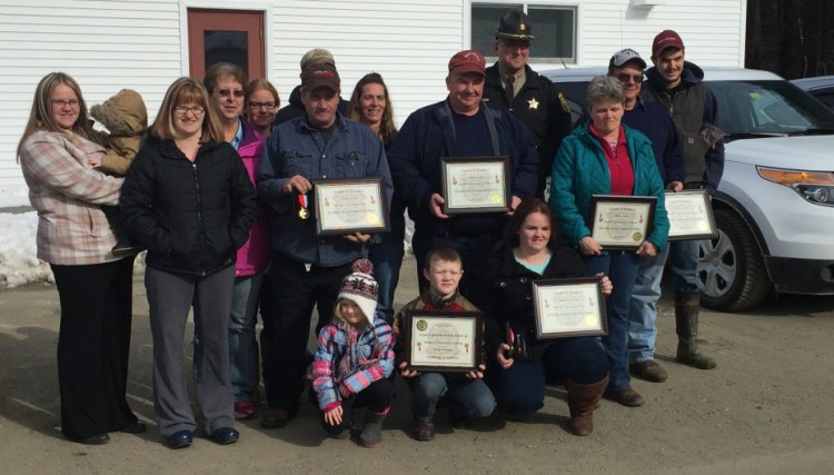 Members of the Lane family were recognized Friday by the Franklin County Sheriff’s Office for their part in helping save the life of a truck driver who was shocked by electric wires while delivering grain to their New Vineyard farm in December. Holding certinficates, from left to right: (front) Nicholas Rowe, Amie Lane, (middle) Ernest Lane, Martin Lane, Becky Lane, and Michael Lane.