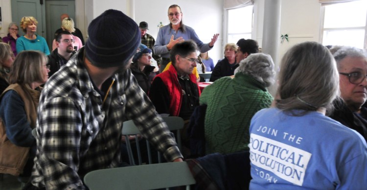 Wilton resident Charles Woodbury makes a point during a well attended Democratic caucus in Wilton on Sunday.