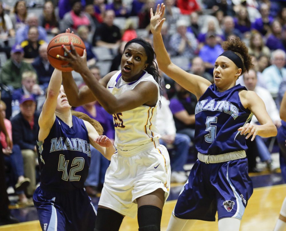 Albany forward Shereesha Richards (25), of Jamaica, works against Maine defenders Sigi Koizar (42) and Bella Swan (5) during the second half an NCAA college basketball game in the America East Conference women’s tournament championship on Friday in Albany, N.Y. Albany won 59-58.