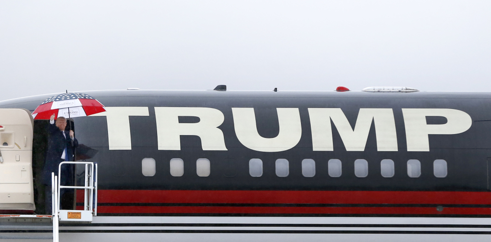 Republican presidential candidate Donald Trump waves to the crowd as he departs a rally Sunday in Bloomington, Ill.