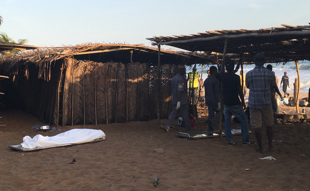 A body lays on the beach were gunmen attacked people in Grand Bassam, Ivory Coast, Sunday.