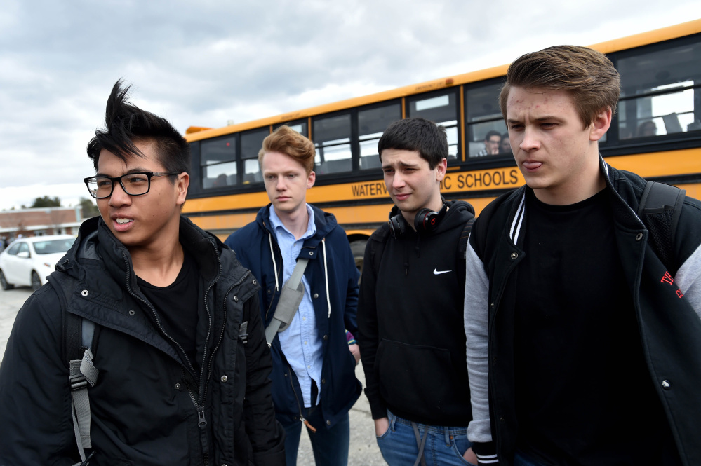 Waterville Senior High School students, from left to right, Chay Phelps, 16, Ulvar Gansum, 17, Andrew Gifford, 17, and Henry Parent, 18, Friday discuss the change to one color of graduation gown.