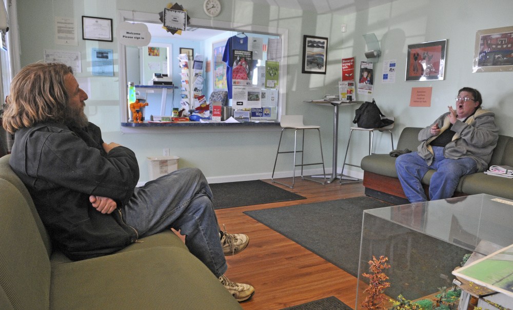 Victor Auger, left, and Alicia Hafford chat in the front room on Friday at LINC Wellness Center in Augusta, which is one of the centers that is at risk of closing.