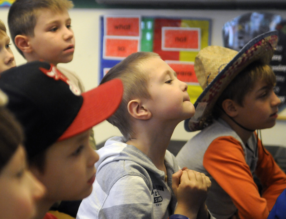 Hussey Elementary School first graders in Arielle Roy’s classroom listen to Augusta businessman John Lajoie read to them on Tuesday during the school’s first read-a-thon. Several local prominent people read to kids as part of initiative to engage them in reading.