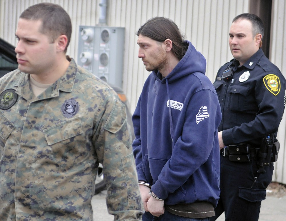 Augusta police officers escort Donald Morang on Thursday to a police cruiser after arresting him at his Augusta apartment on drug trafficking charges.