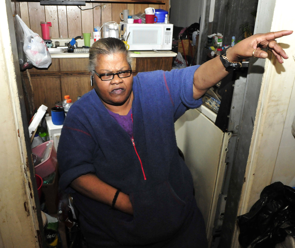 Janette Jones, a tenant at 58 Silver St. in Waterville, speaks Monday about the suspicious fire that damaged part of a lobby outside her apartment late Sunday.