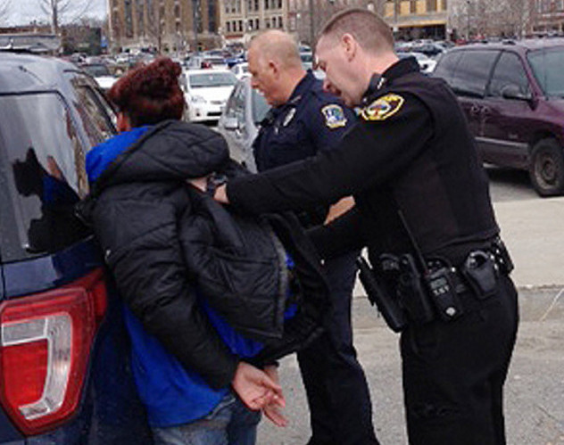 Renee Jurdak is arrested Tuesday afternoon on The Concourse parking lot in Waterville. At left is Waterville police Officer Timothy Hinton and Winslow police Officer John Veilleux is at right.