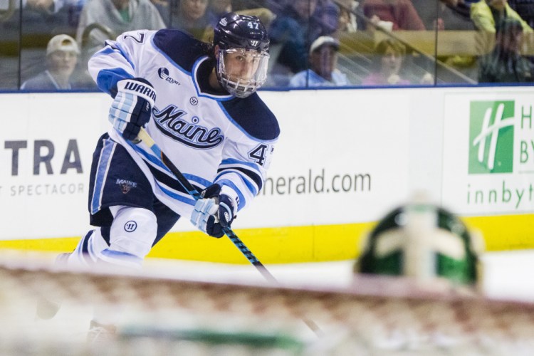 Ben McCanna/Staff Photographer
UMaine forward Mark Hamilton shoots on Michigan State goaltender Jake Hildebrand. The Black Bears face Northeastern this weekend in a best-of-three series in the first round of the Hockey East Playoffs.