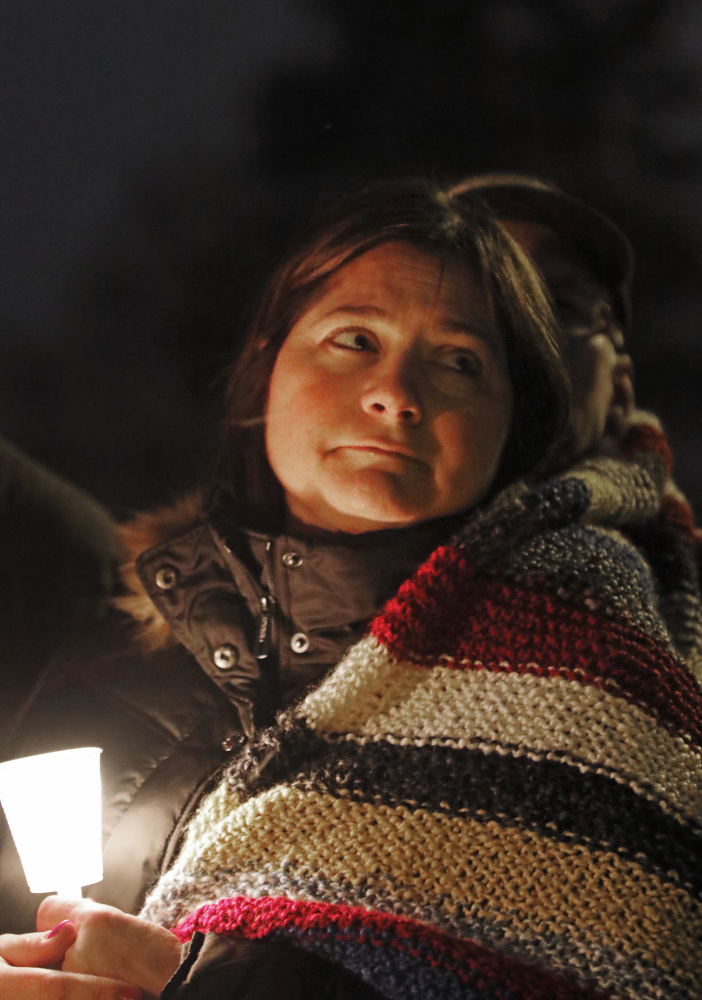 Elaina Breunig, David Breunig’s mother, is wrapped in the prayer shawl during the vigil for her son on Portland’s Western Promenade.