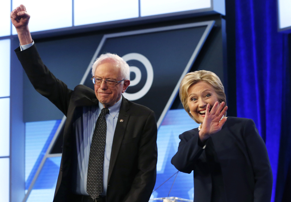 Hillary Clinton and Sen. Bernie Sanders, I-Vt., take the stage before the start of the Univision, Washington Post Democratic presidential debate in Miami on Wednesday.