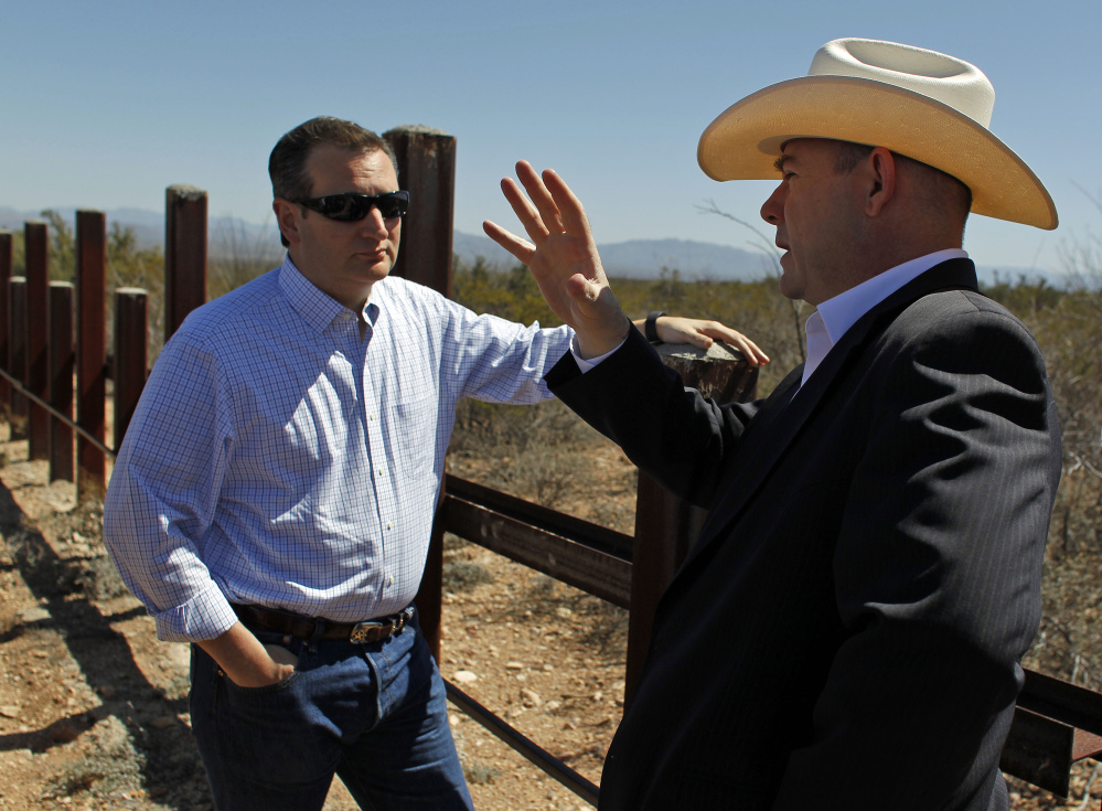 Arizona House Speaker David Gowan, right, speaks with Republican presidential candidate Sen. Ted Cruz of Texas during a visit to the Mexican border in Douglas on Friday.