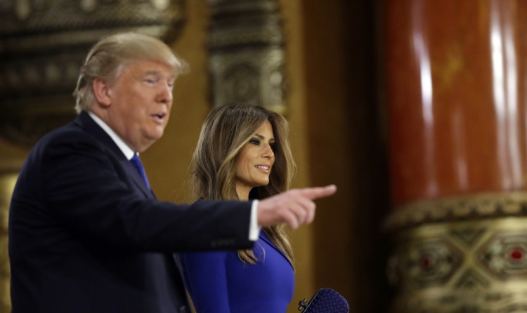 Republican presidential candidate and businessman Donald Trump and his wife Melania arrive at the spin room after a Republican presidential primary debate on March 3, 2016, in Detroit. The Associated Press