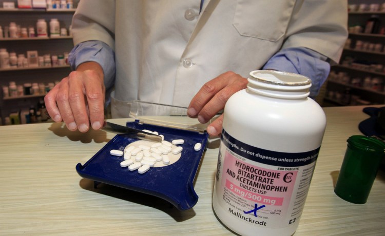 A pharmacist counts out pills of Vicodin at a pharmacy in Portland. Maine was one of the first states to see an explosion of painkiller addiction and is still one of the worst states in the nation for pill abuse. Citing the rash of pharmacy robberies involving painkiller pills, the pharmacist asked that he and the pharmacy not be identified. Gregory Rec/Staff Photographer 
