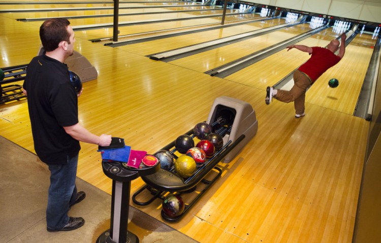Terry Robinson of Gray watches as Portland’s Brian Owoc bowls Monday at Bayside Bowl. The two will compete against pro bowlers there next week.