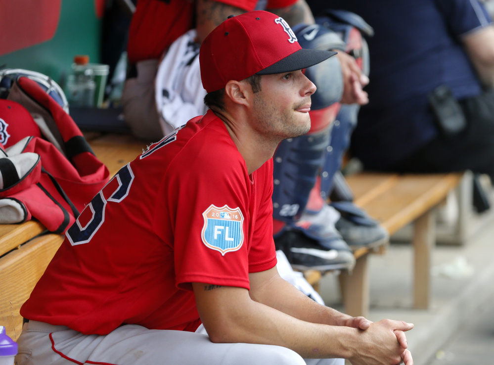 Boston Red Sox's Joe Kelly sits in the dugout in the third inning of a spring training baseball game against the Minnesota Twins on Tuesday, March 29, 2016, in Fort Myers, Fla. (AP Photo/Tony Gutierrez)
