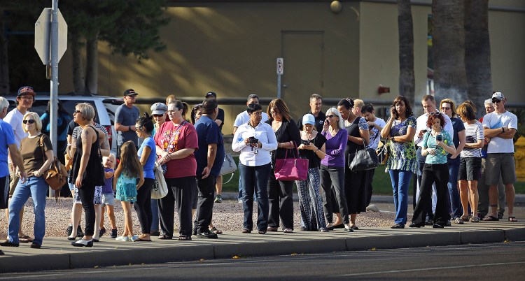 People wait in line to vote in Arizona's presidential primary Tuesday in Phoenix. Some voters in Arizona waited two hours to cast primary ballots.