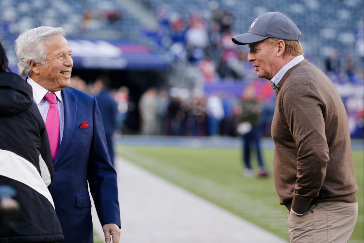 New England Patriots owner Robert Kraft, left, speaks with NFL commissioner Roger Goodell before a game in East Rutherford, N.J. Kraft has asked the commissioner to reinstate the Patriots' lost first-round draft pick.