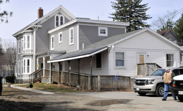 State fire marshal investigator Ken MacMaster prepares to re-enter 73 Pleasant St. in Waterville while investigating a fire that occurred early Sunday morning. Residents at the home run by Motivational Services Inc. have been temporarily relocated.