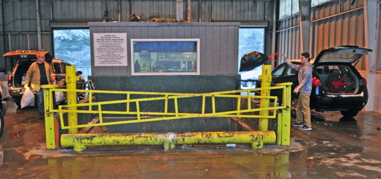 People toss trash bags at the Winthrop Transfer Station in this February file photo.