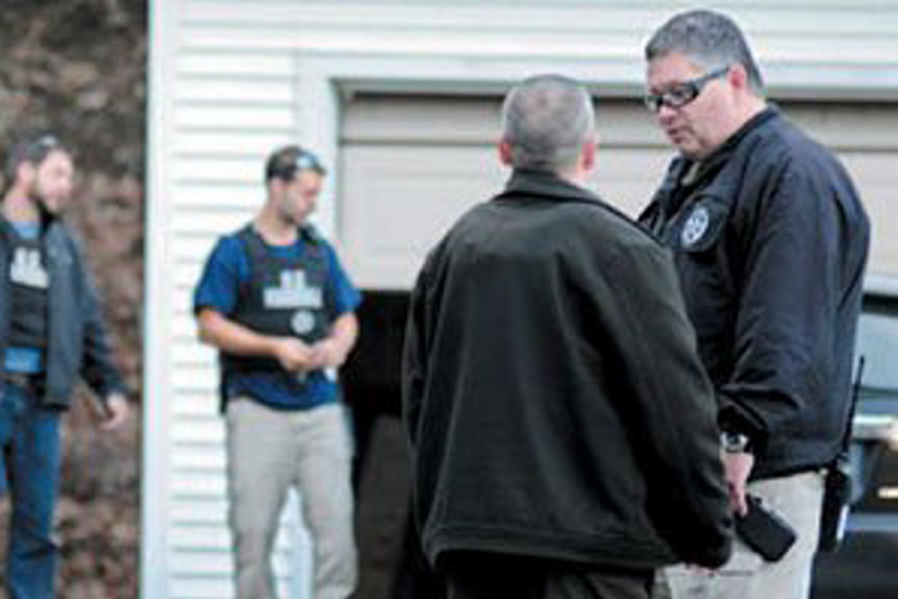 U.S. Marshals Service investigators search the residence of Barbara Cameron, the ex-wife of James Cameron, in November 2012 in Hallowell. Authorities spent more than two weeks looking for Cameron that year after he cut off his electronic monitoring bracelet and drove to New Mexico before being captured. Maine's former top drug prosecutor fled the state after learning his appeal of child pornography convictions had failed.