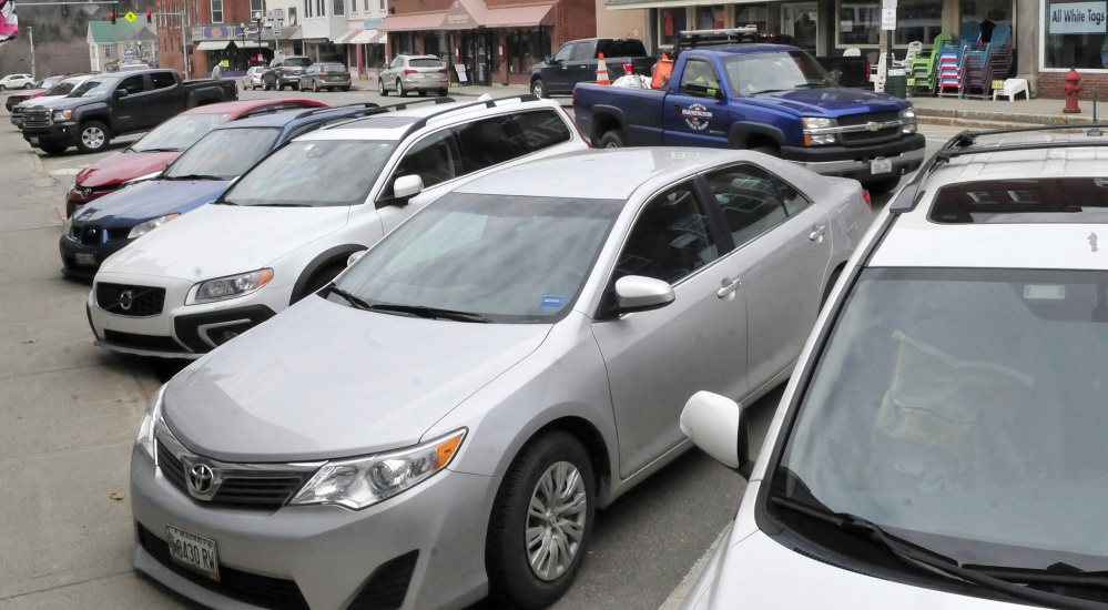 Parking spaces along Main Street in Farmington are filled with vehicles recently. The town plans to build a 28-space lot on Church Street.